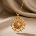Achernar Star Pendant Necklace in Gold Plated Silver with a textured radial starburst on beige draped fabric