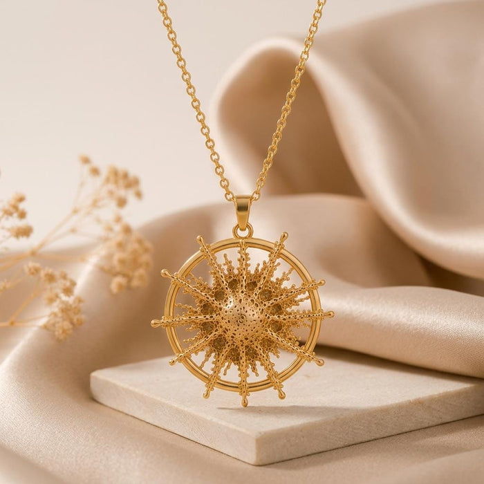 Close-up of the Gold Plated Silver Achernar radial starburst pendant with a circular open frame