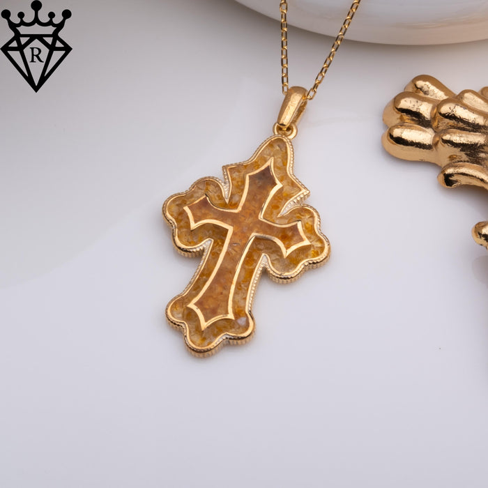 Angled Amber Cross Necklace close-up showing the textured inset and polished border