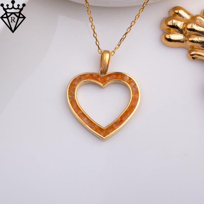 Front product photograph of an amber-colored open heart pendant on a white surface, catalog view 3