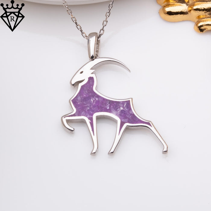 Amethyst Capricorn goat pendant with a long curved horn and purple body inset