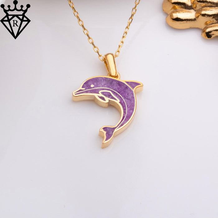 Angled detail of the dolphin's curved purple body, lower flipper and polished metal outline