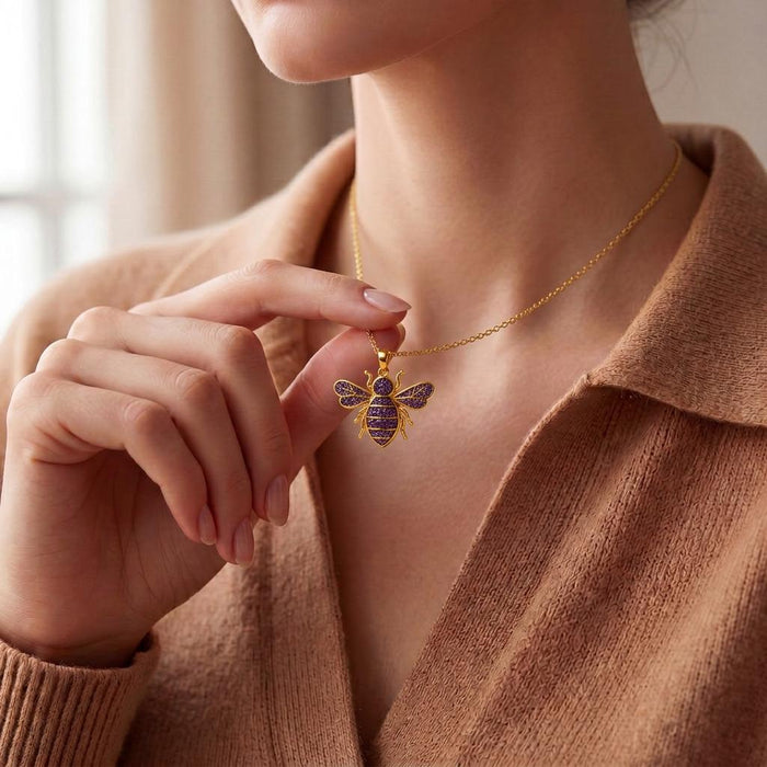 Model holding a Gold Plated Silver Amethyst Druzy Bee Necklace at the neckline