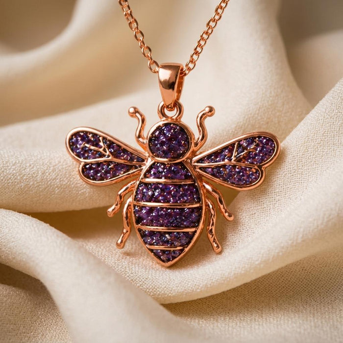 Rose Gold Plated Amethyst Druzy Bee Necklace close-up on ivory fabric