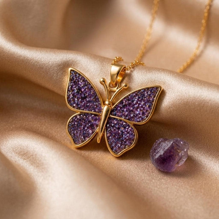 Gold Plated Silver butterfly pendant on champagne satin with four textured purple wing panels and a purple stone prop