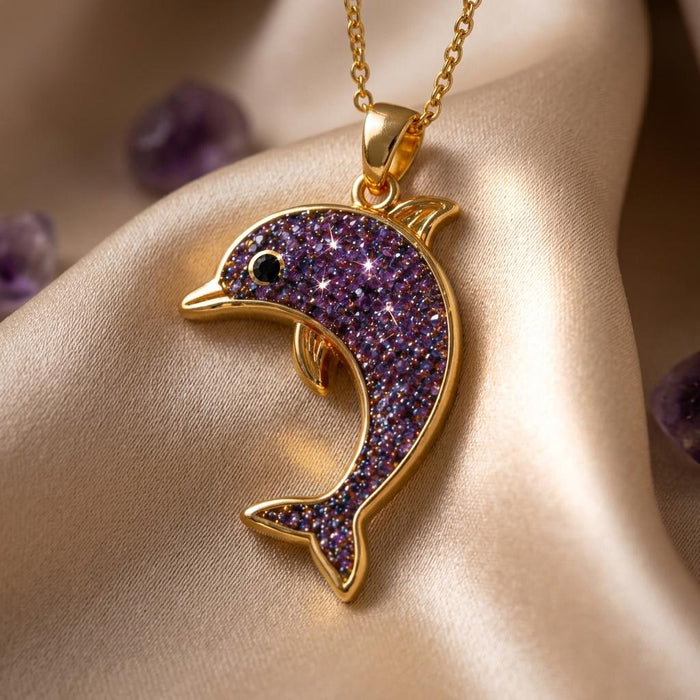 Gold Plated Silver Amethyst Druzy Dolphin Necklace with textured purple dolphin body on champagne fabric
