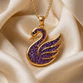 Gold Plated Silver Amethyst Druzy Swan Pendant Necklace on champagne satin with a textured purple swan body