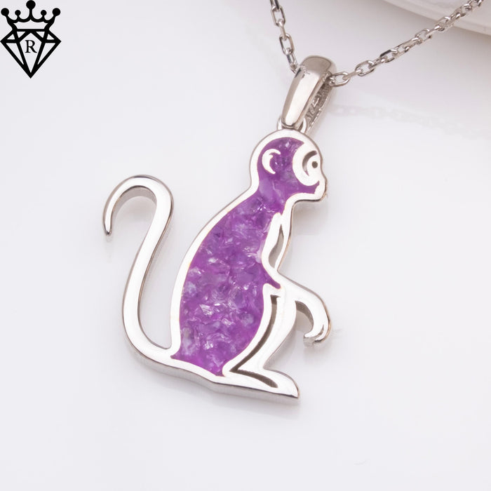 Pendant detail showing the circular ear, purple body accent and curled tail