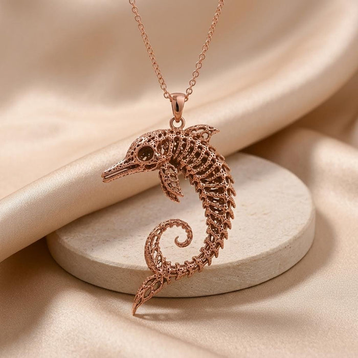 Rose Gold Plated Ancient Dolphin Fossil Necklace with a curled skeletal dolphin pendant above a round display