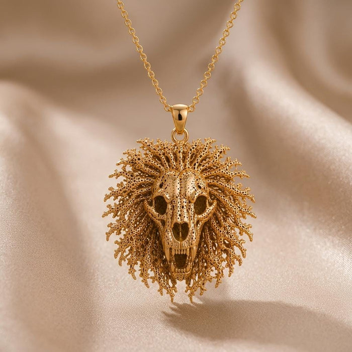 Gold Plated Silver Ancient Lion Skull Crest Necklace with a textured radiating mane on beige fabric