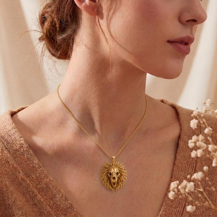 Gold Plated Silver Ancient Lion Skull Crest Necklace worn at the collarbone with a knit top