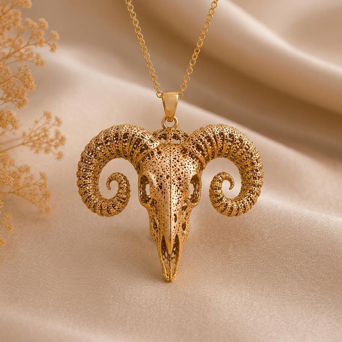 Gold Plated Silver Ancient Ram Skull Pendant necklace on champagne fabric with dried flower stems
