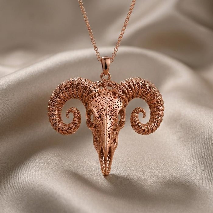 Straight-on close view of the Rose Gold Plated Ancient Ram Skull Pendant with perforated skull texture and curled horn ridges