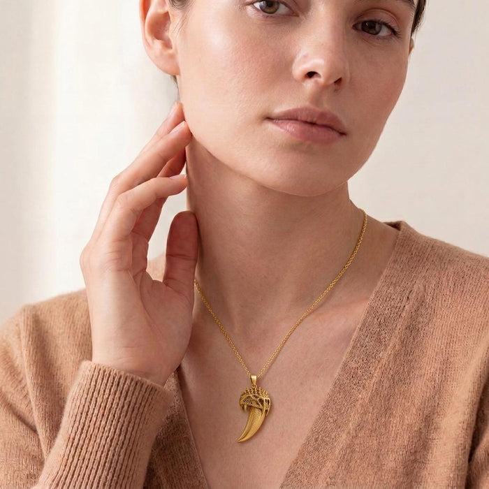 Model wearing the Gold Plated Silver Ancient Saber Tooth Pendant with a V-neck neutral knit top