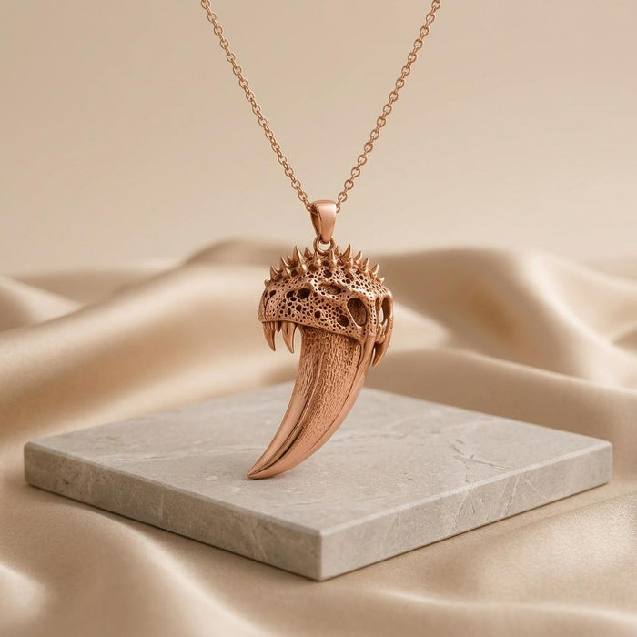 Rose Gold Plated Ancient Saber Tooth Pendant displayed above a pale stone slab