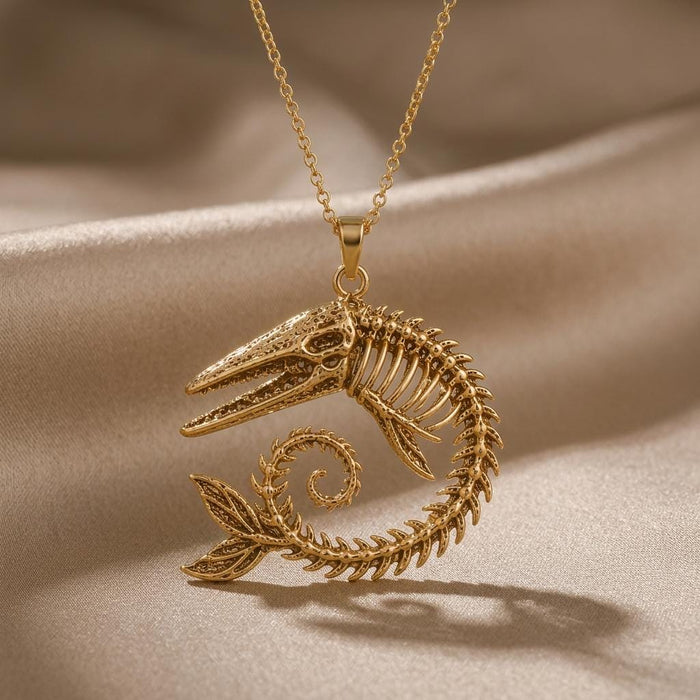 Gold Plated Silver Ancient Whale Fossil Pendant Necklace with curled skeletal whale design on champagne satin