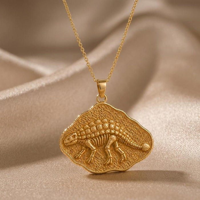 Gold Plated Silver Ankylosaurus fossil pendant necklace on champagne satin