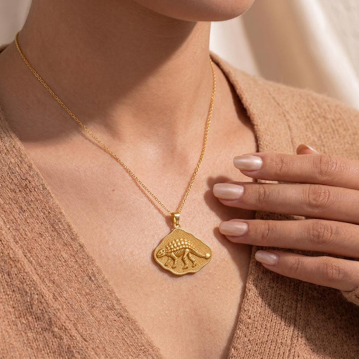 Close view of a Gold Plated Silver Ankylosaurus fossil pendant necklace worn at the collarbone
