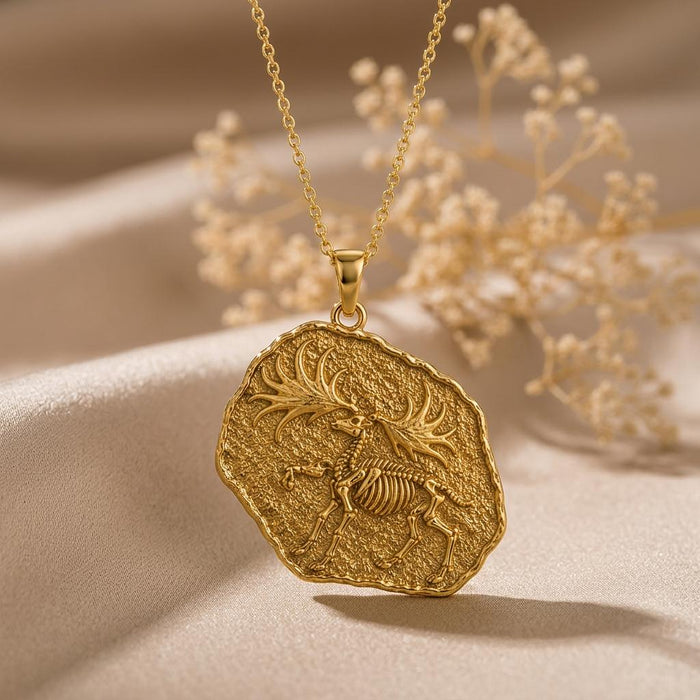 Gold Plated Silver Dire Wolf Fossil Pendant Necklace with raised skeletal relief on champagne satin