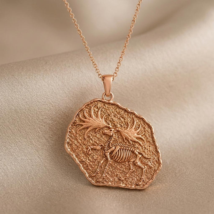 Close-up of Rose Gold Plated Dire Wolf Fossil Pendant Necklace showing raised skeletal relief on a textured fossil disc