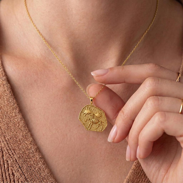 Gold Plated Silver Dire Wolf Fossil Pendant Necklace worn at the neckline beside a hand