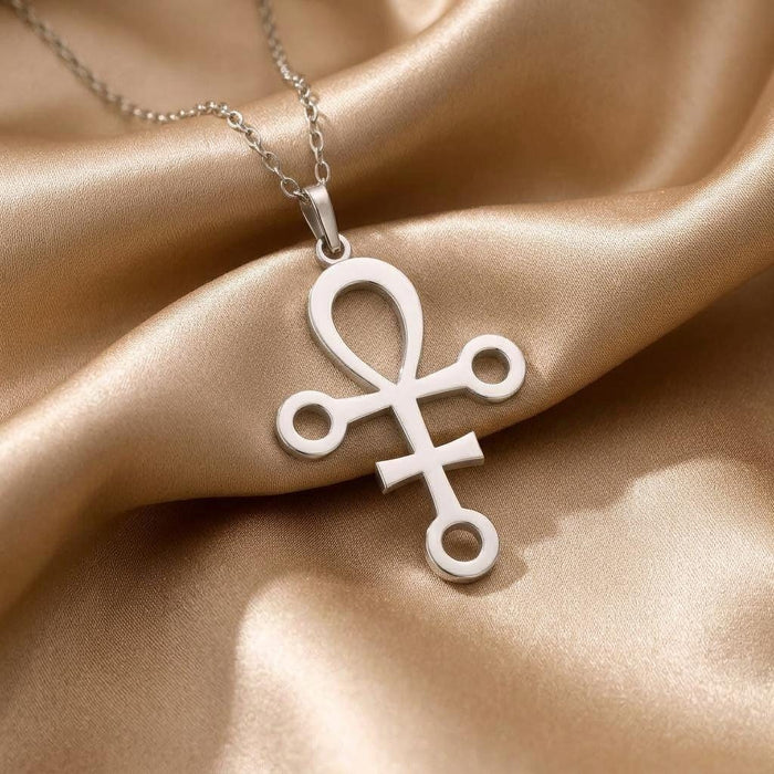 Close-up of the openwork Anubis symbol pendant on gold satin