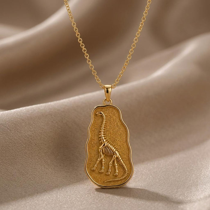 Gold Plated Silver Argentinosaurus fossil pendant necklace with raised skeleton relief on champagne satin