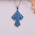 Blue Azurite inlay cross pendant necklace with raised inner cross outline on pale fabric