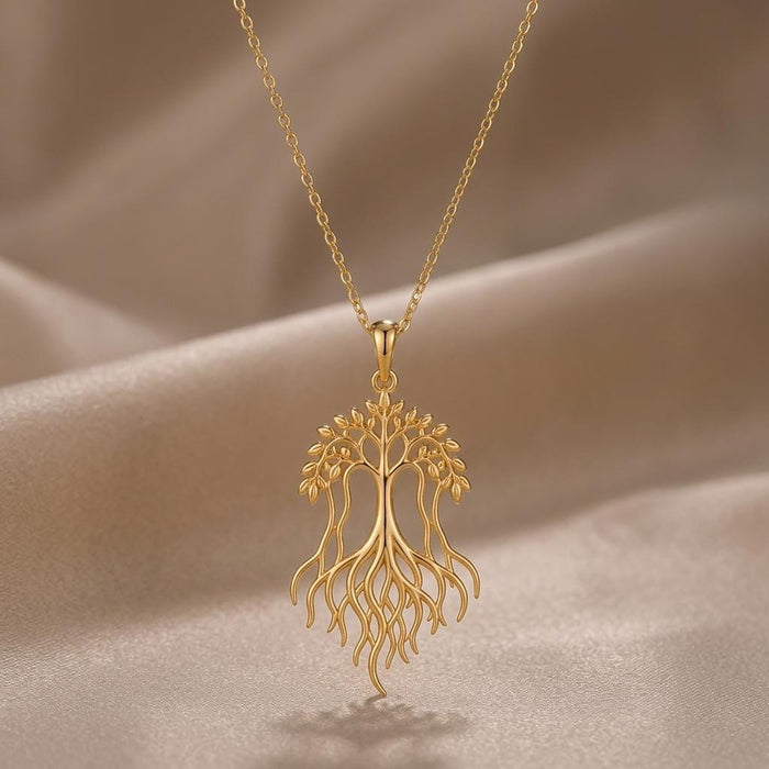 Gold Plated Silver Banyan Flow Necklace with an openwork branching tree and flowing roots on champagne satin