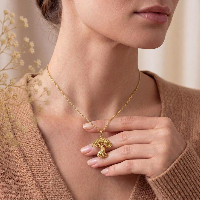 Model holding a Gold Plated Silver Ficus Flow Pendant at the neckline