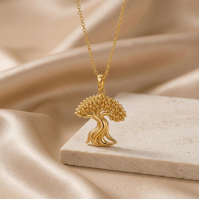 Gold Plated Silver Ficus Flow Pendant with flowing trunk lines on a pale stone block
