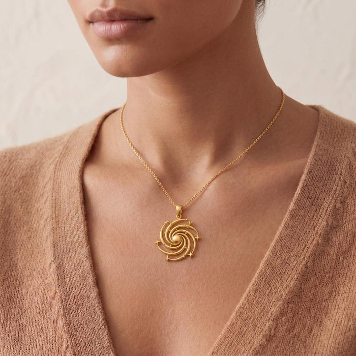 Close view of a Gold Plated Silver Spiral Galaxy Pendant Necklace at the neckline