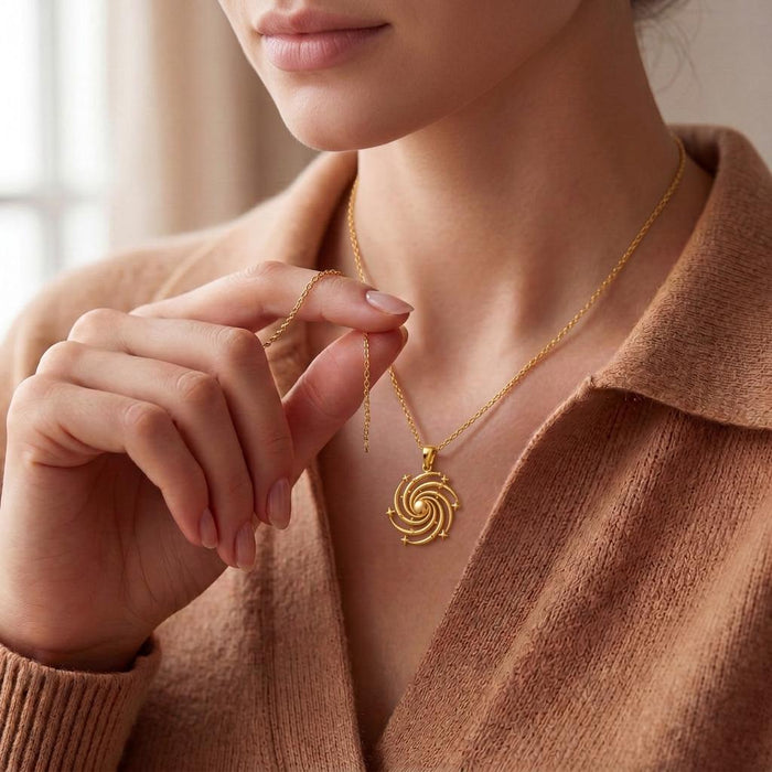 Model holding the extender chain beside a Gold Plated Silver Spiral Galaxy Pendant Necklace