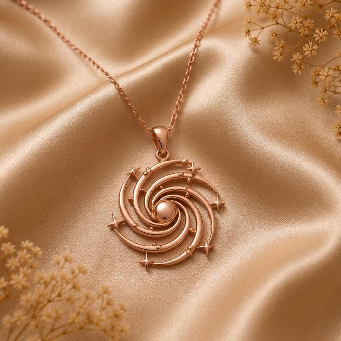 Rose Gold Plated Spiral Galaxy Pendant Necklace with star-shaped accents on champagne satin