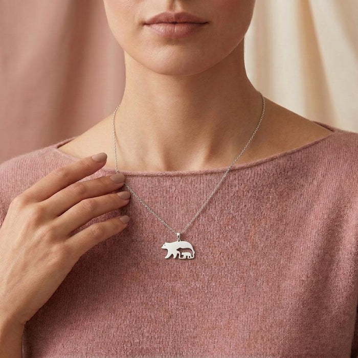 Model wearing the Bear and Cub Necklace with a pink knit top