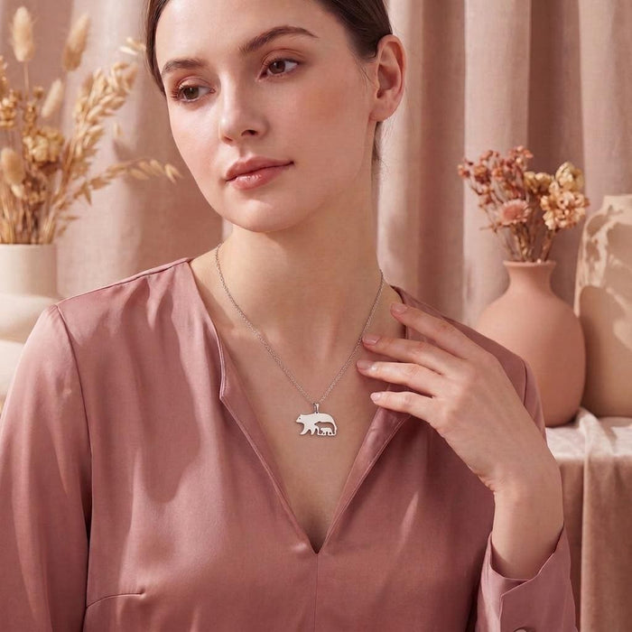 Model wearing the Bear and Cub Necklace with a pink blouse