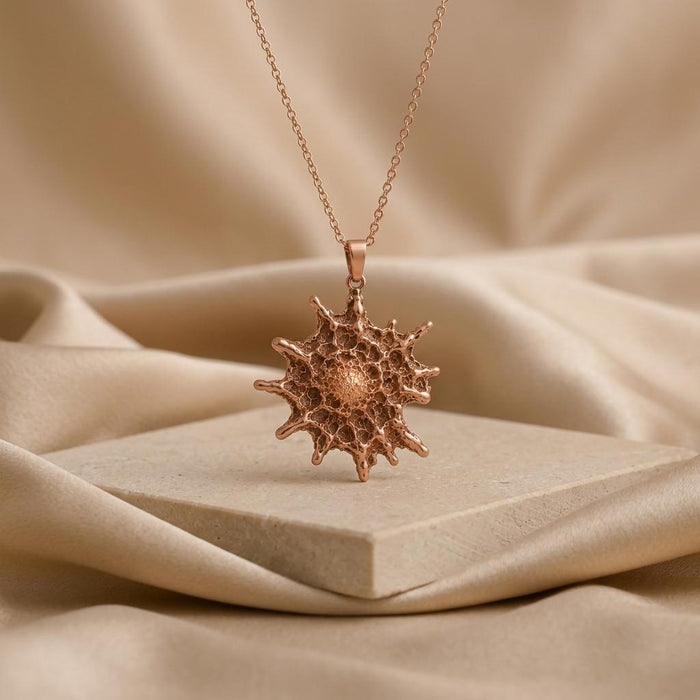 Rose Gold Plated Betelgeuse star pendant displayed on a pale stone block