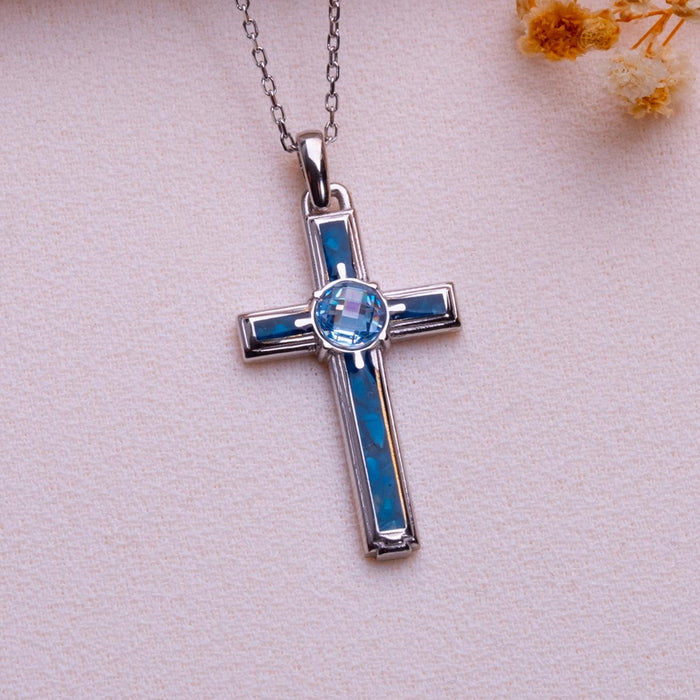 Blue Agate Cross Necklace in Silver with framed blue agate inlay and round center accent on pale fabric