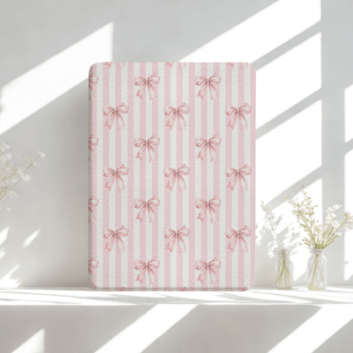 Blush pink Kindle case with bow pattern, built-in hand strap and back magnets