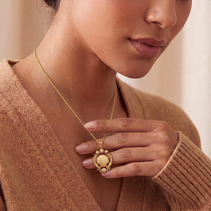 Model wearing a Gold Plated Silver Shell Halo Pendant Necklace with a ridged shell and star detail