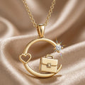 Incorrect Gold Plated Silver circular briefcase-and-heart pendant necklace on champagne fabric