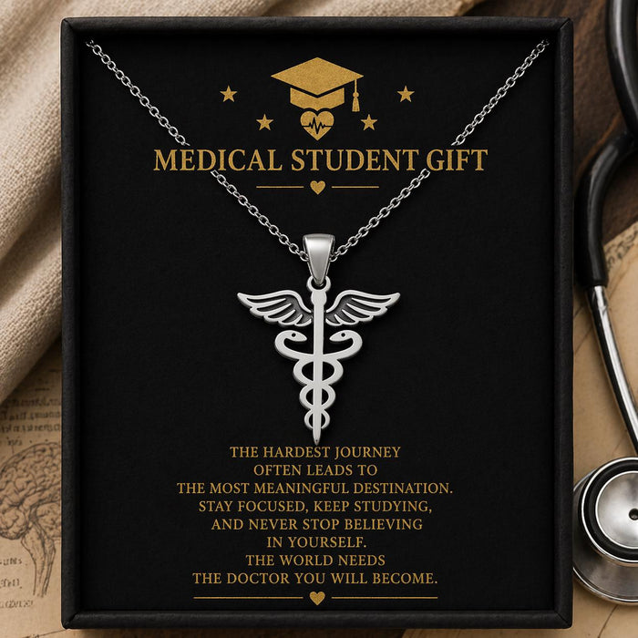 Silver Caduceus Necklace displayed in a black presentation box beside a stethoscope
