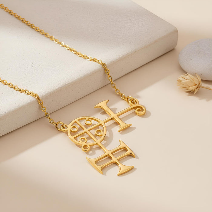Gold Plated Silver Buer seal pendant necklace displayed on a stone surface