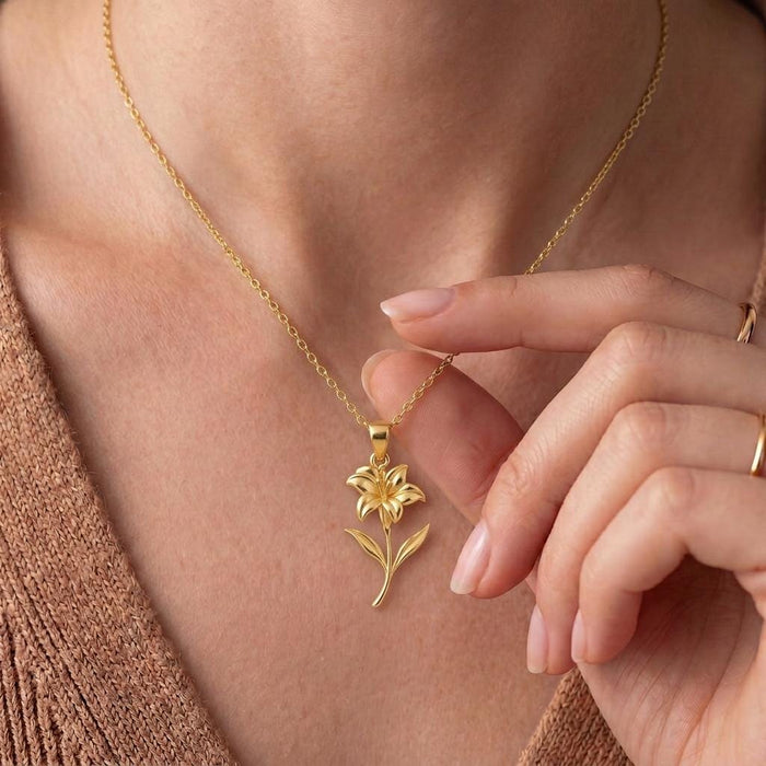 Gold Plated Silver Canna Flower Pendant Necklace worn at the neckline with a hand beside the pendant