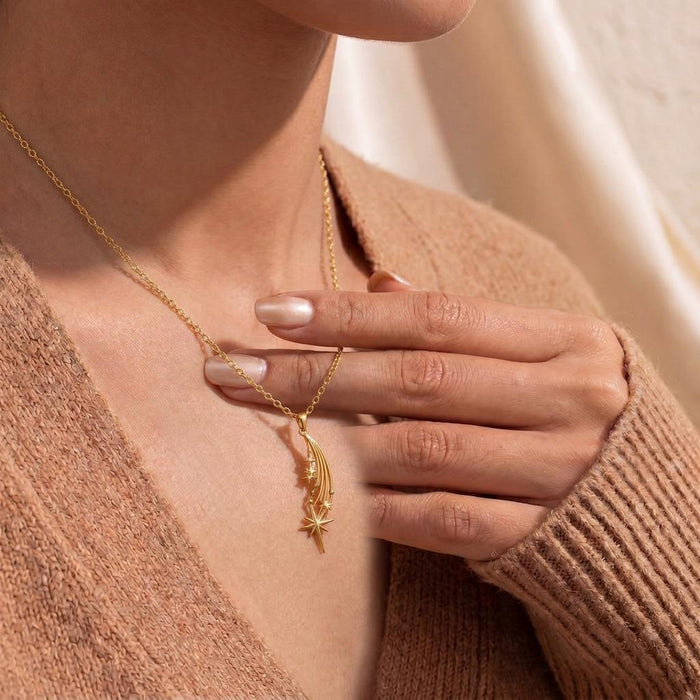 Gold Plated Silver Falling Star Pendant Necklace worn with a knit cardigan in a close neckline view