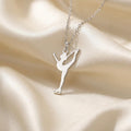 Close-up of a silver catch-foot Figure Skater Necklace with a visible supporting skate blade on ivory satin