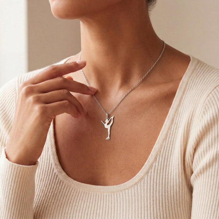 Silver catch-foot Figure Skater Necklace worn with a cream ribbed sweater