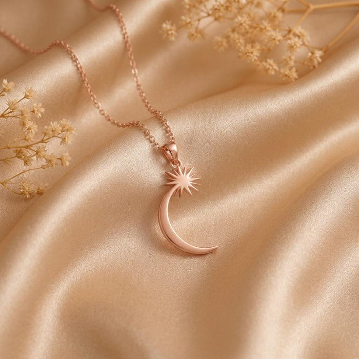Rose Gold Plated Celestial Crescent Star Necklace with a radiant pointed star and crescent on satin with dried flowers
