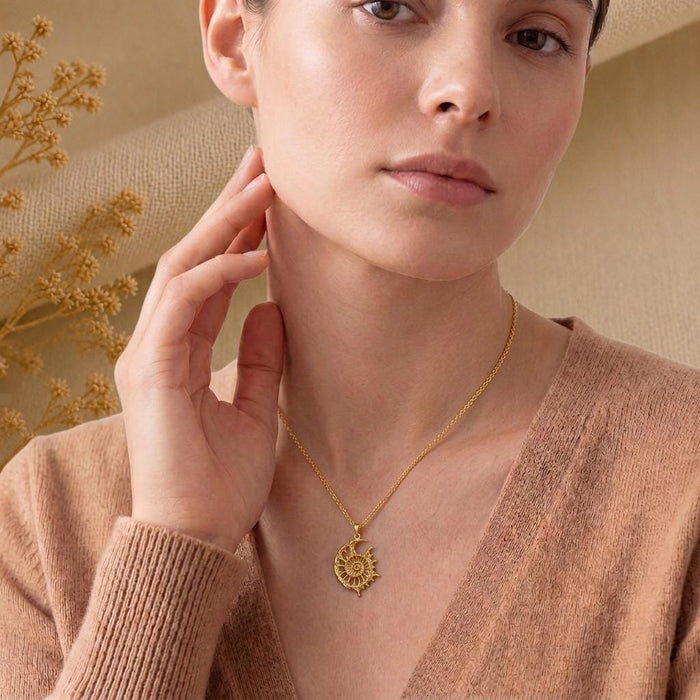 Gold Plated Silver Celestial Fossil Pendant Necklace worn at the neckline with a soft knit top