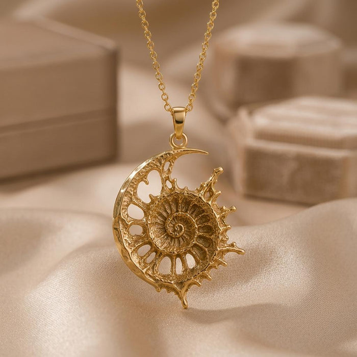 Close-up of the Gold Plated Silver Celestial Fossil Pendant Necklace with openwork crescent cutouts and spiral center